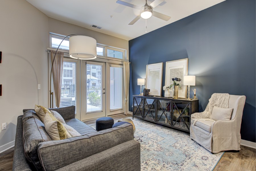 Apartment living room with area rug and view to the exterior.